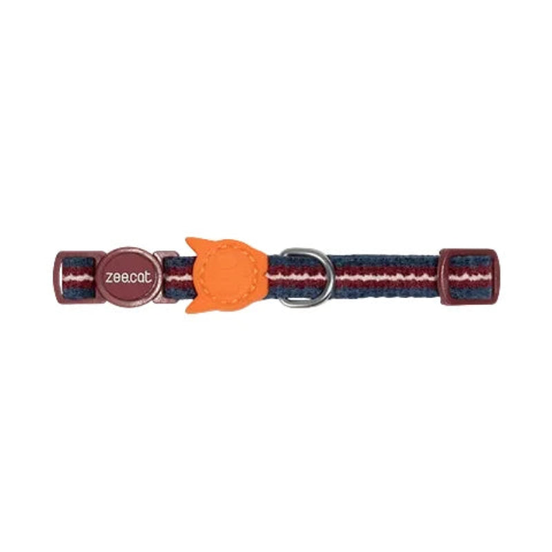 A woven cat collar with a navy, red, and white striped pattern, featuring a bright orange cat-shaped leather accent and a silver metal D-ring. The brand name 'zeecat' is visible on the left metal ring.